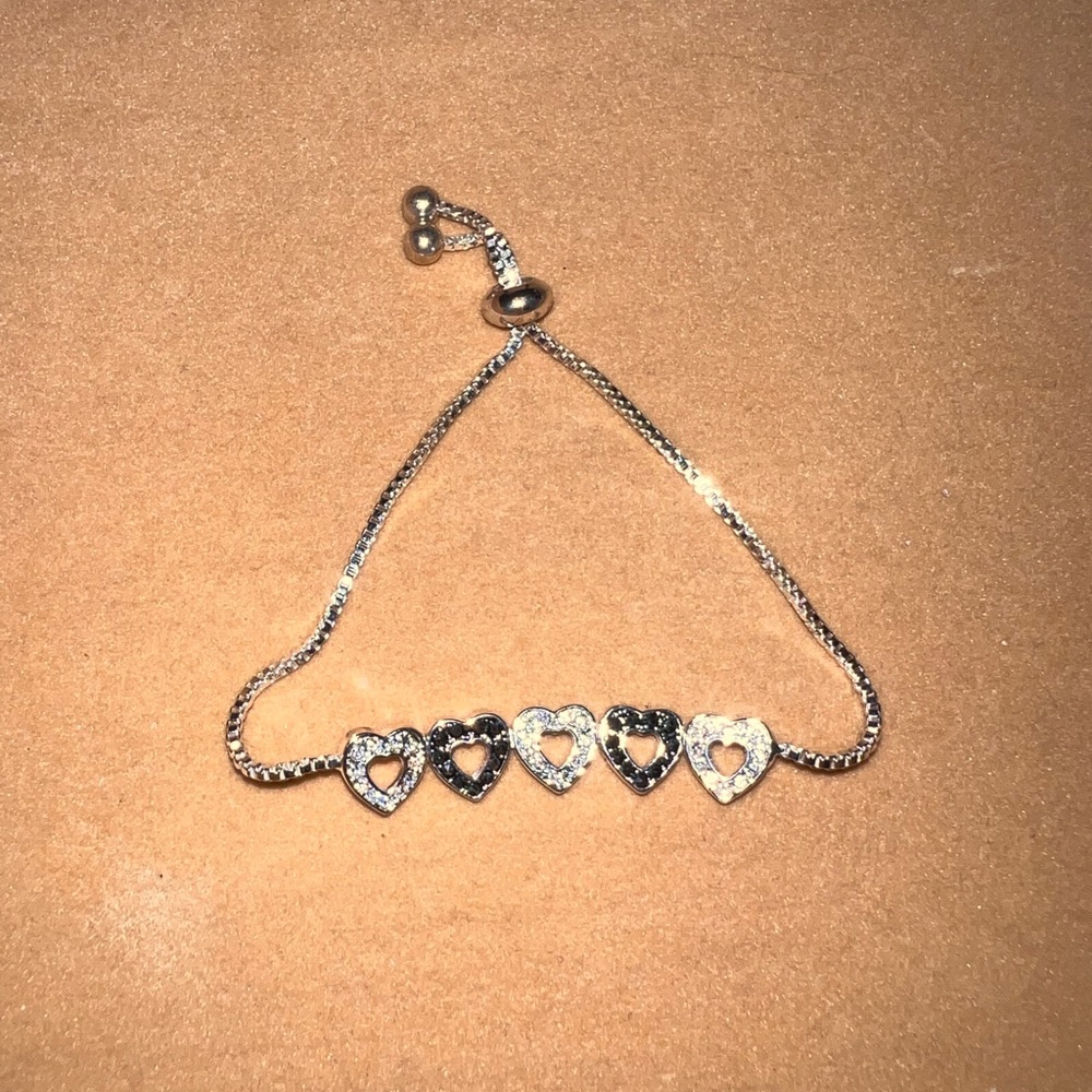 Silver tone Lariat Bracelet with black and clear pave crystal hearts